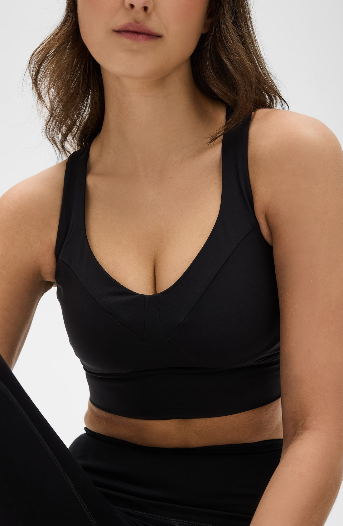 Le Divine Lymphatic Bra in solid olive-green, featuring a minimalist design and supportive athletic construction.