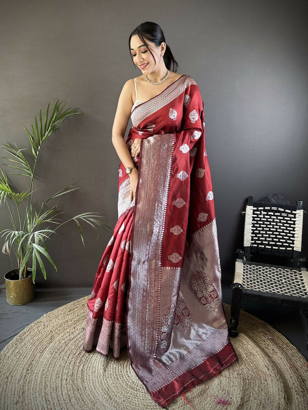 Maroon floral motif soft silk Banarasi saree with matching blouse draped elegantly
