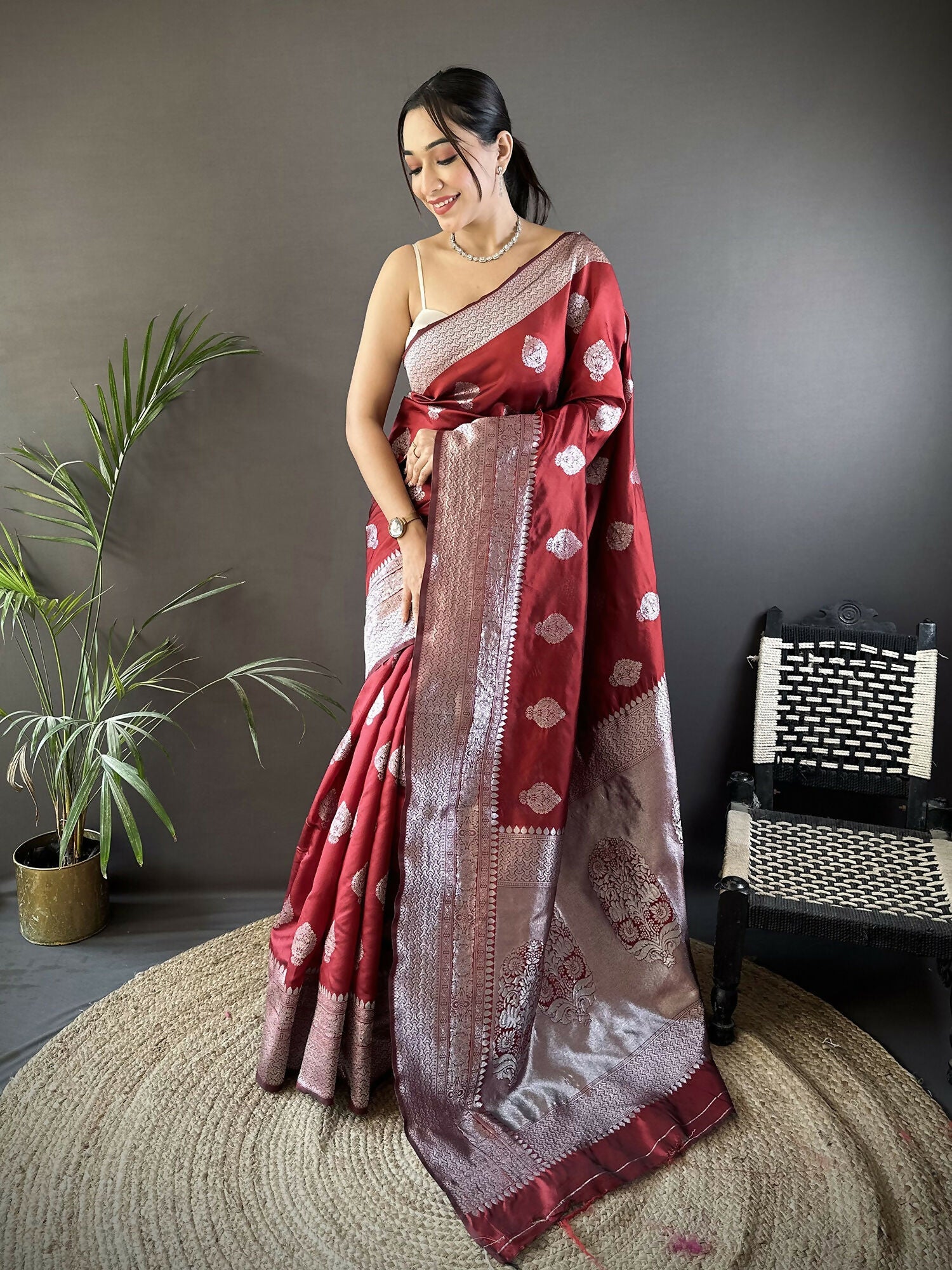 Maroon floral motif soft silk Banarasi saree with matching blouse draped elegantly