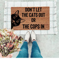 A humorous brown doormat with black text reading 'Don't Let The Cats Out Or The Cops In'.