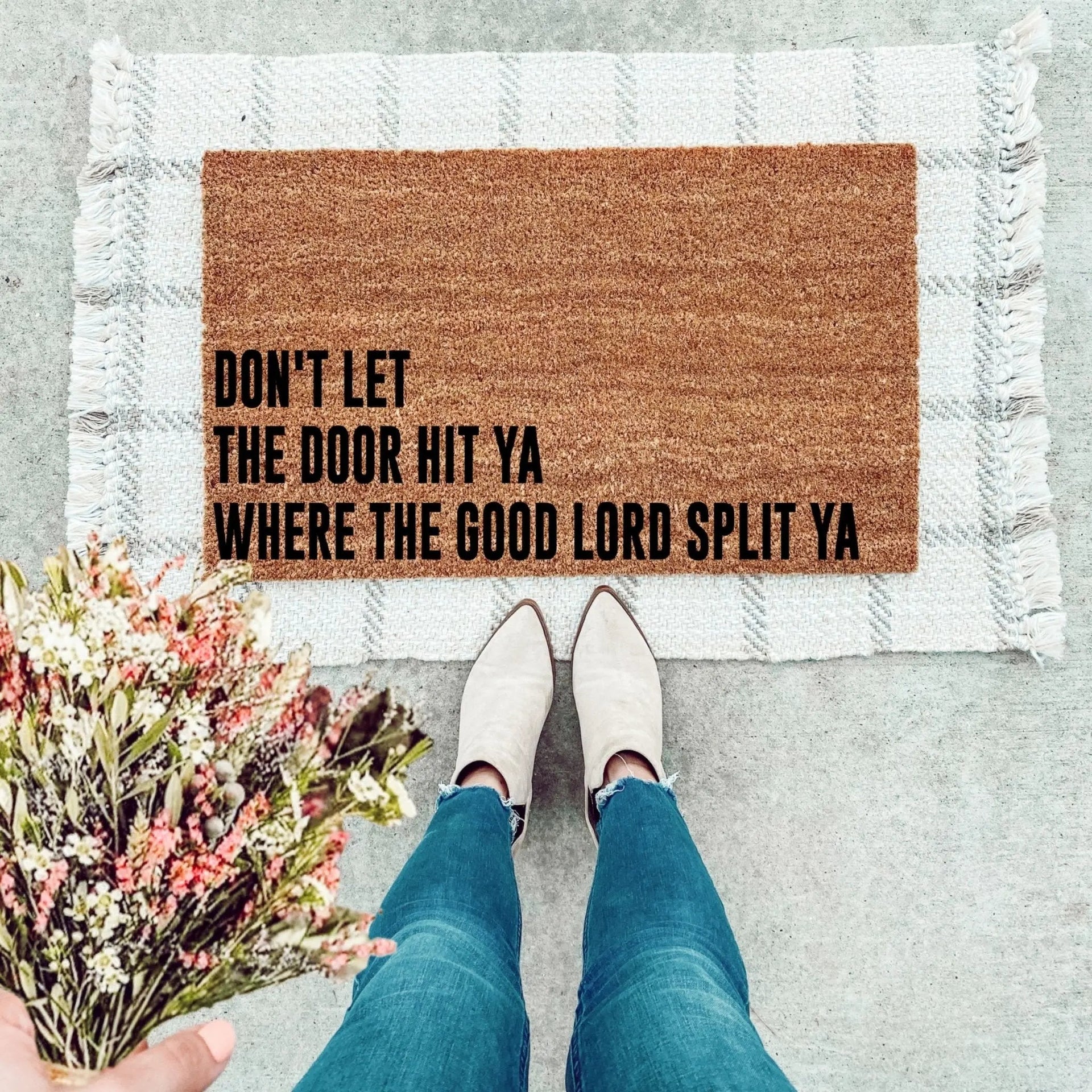 Funny natural coir doormat with text reading Don't Let The Door Hit Ya Where The Good Lord Split Ya