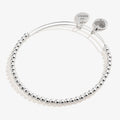 Minimalist dot beaded bracelet available in gold and silver finish on a neutral background