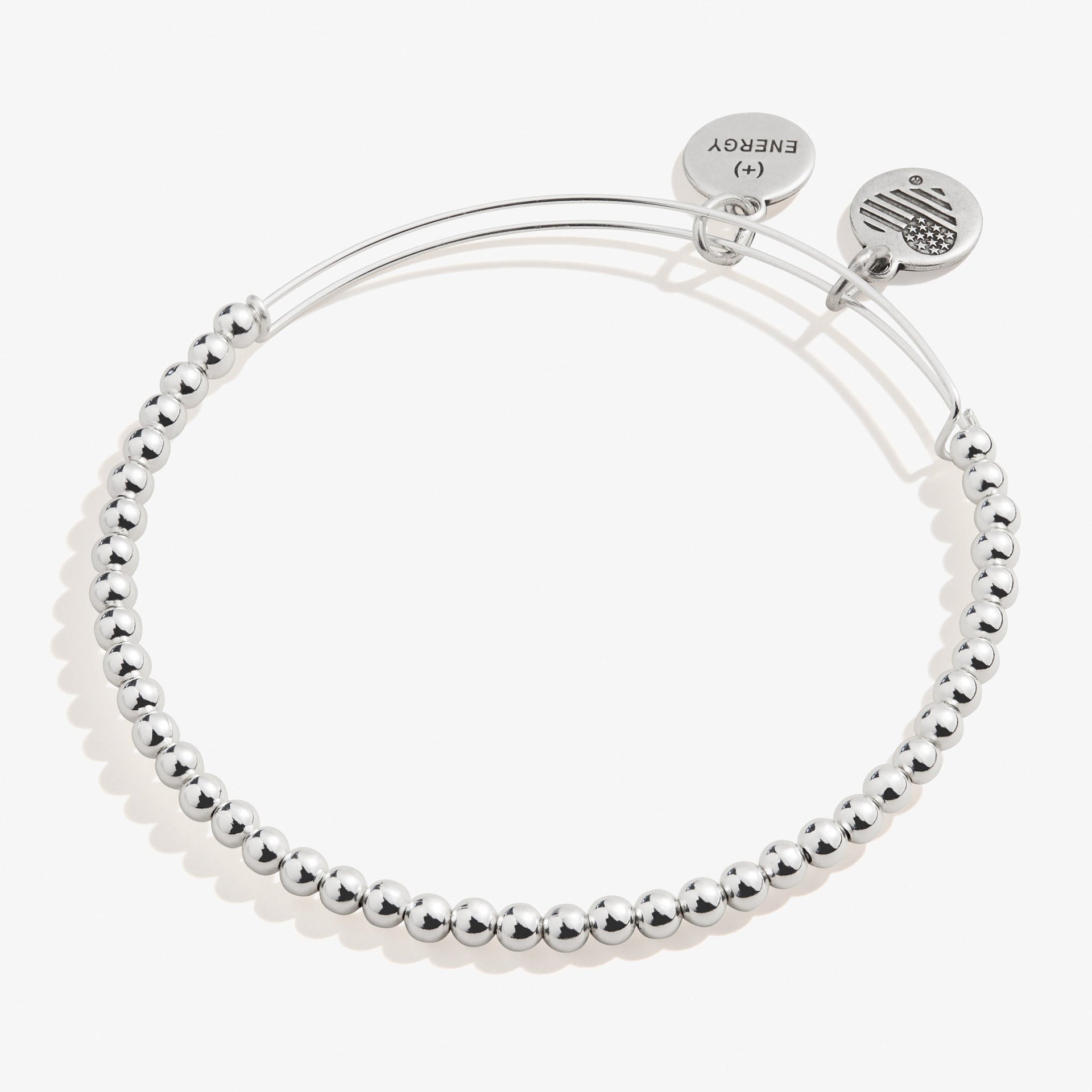 Minimalist dot beaded bracelet available in gold and silver finish on a neutral background