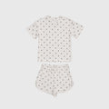 Girl wearing Annie bamboo short set in creamy off-white with charcoal polka dots