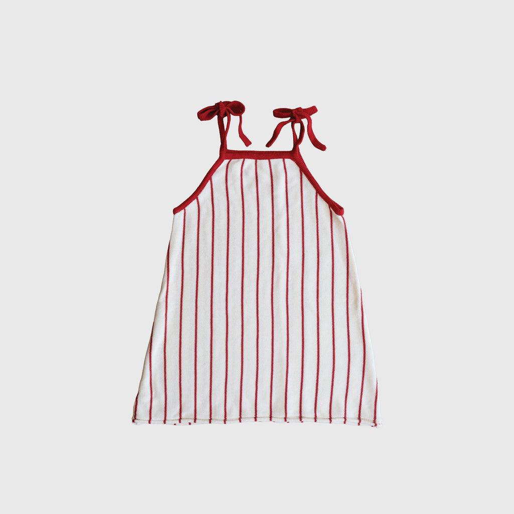 Girl wearing a red and white pinstriped sleeveless knit A-line dress with tie straps