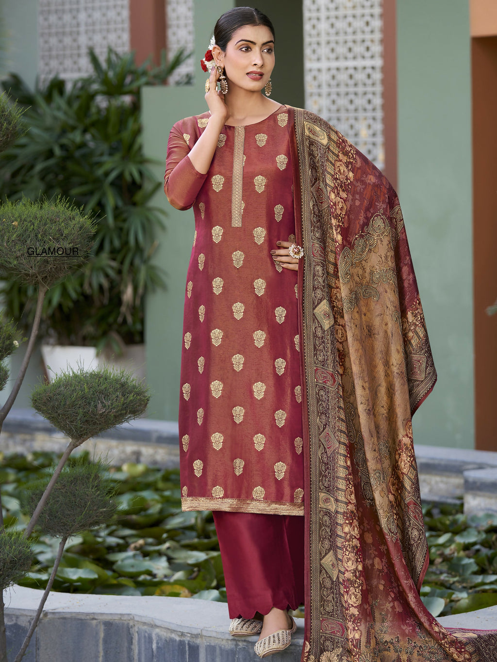 Woman wearing a maroon pure silk jacquard woven kurta set with matching trousers and a digital print dupatta.