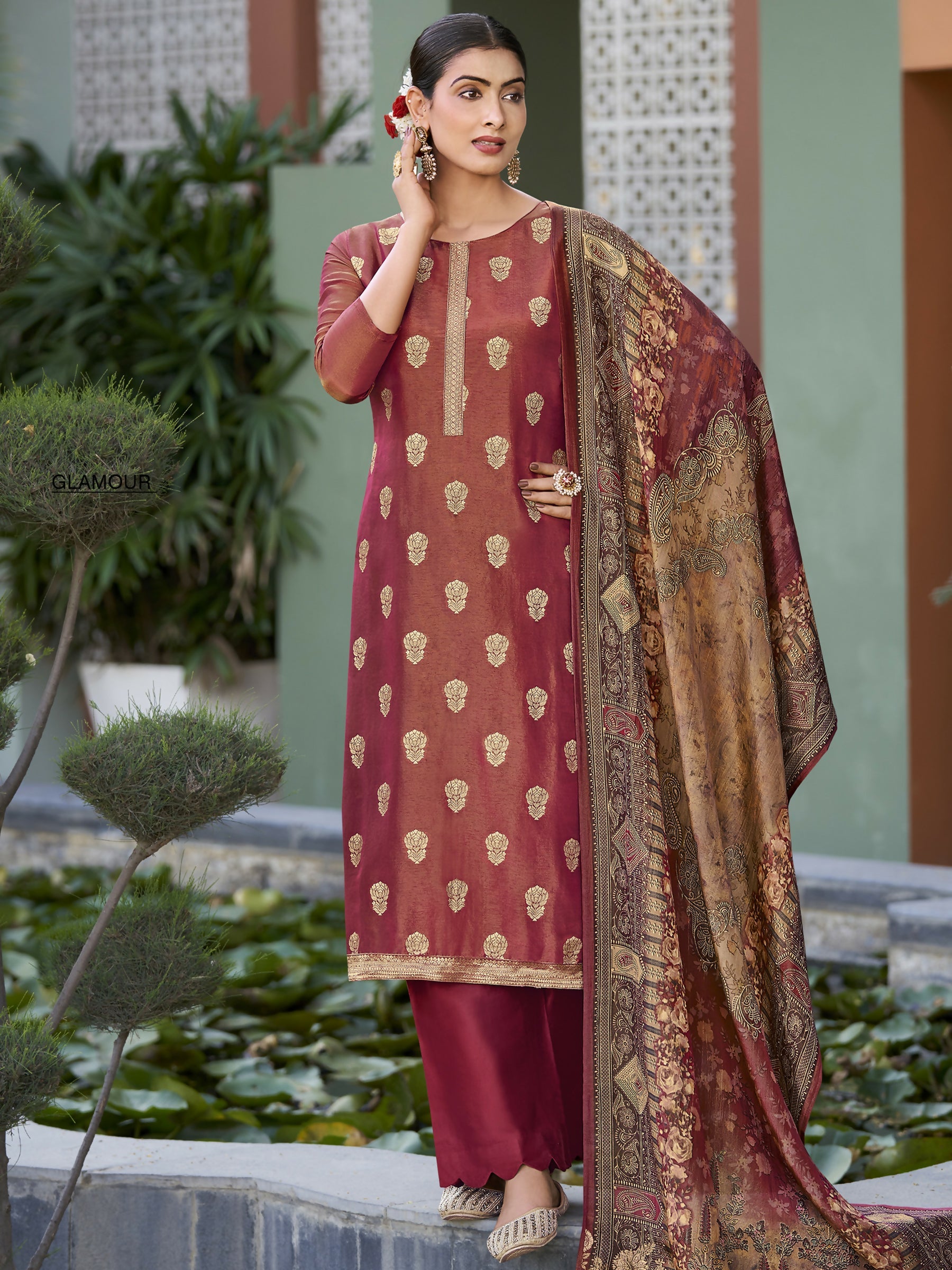 Woman wearing a maroon pure silk jacquard woven kurta set with matching trousers and a digital print dupatta.