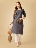 Woman wearing a grey Cotton Magic Slub embroidered kurta pant set with sequence work
