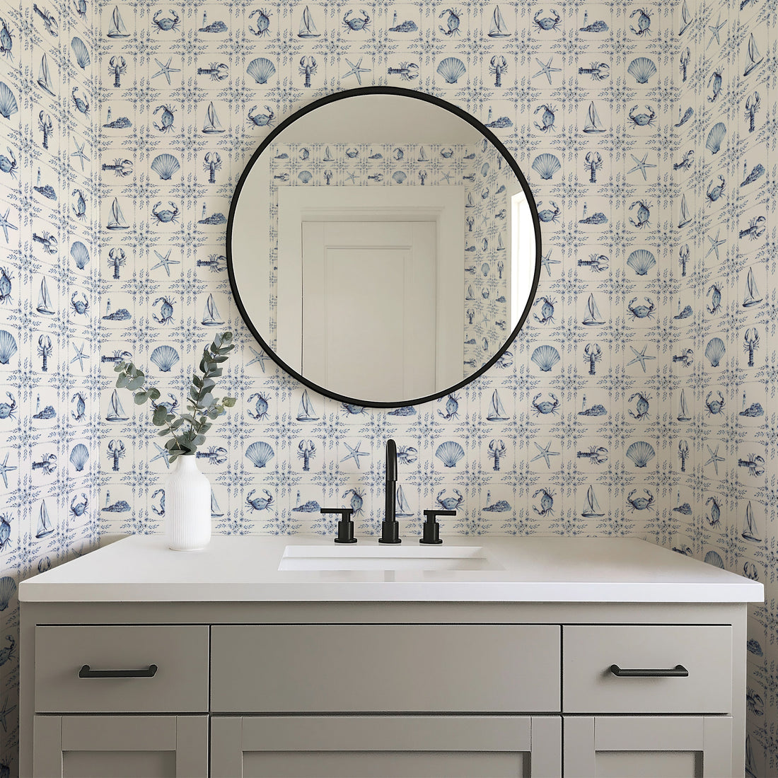 Dulcie blue and white patterned wallpaper in a coastal style bedroom setting.