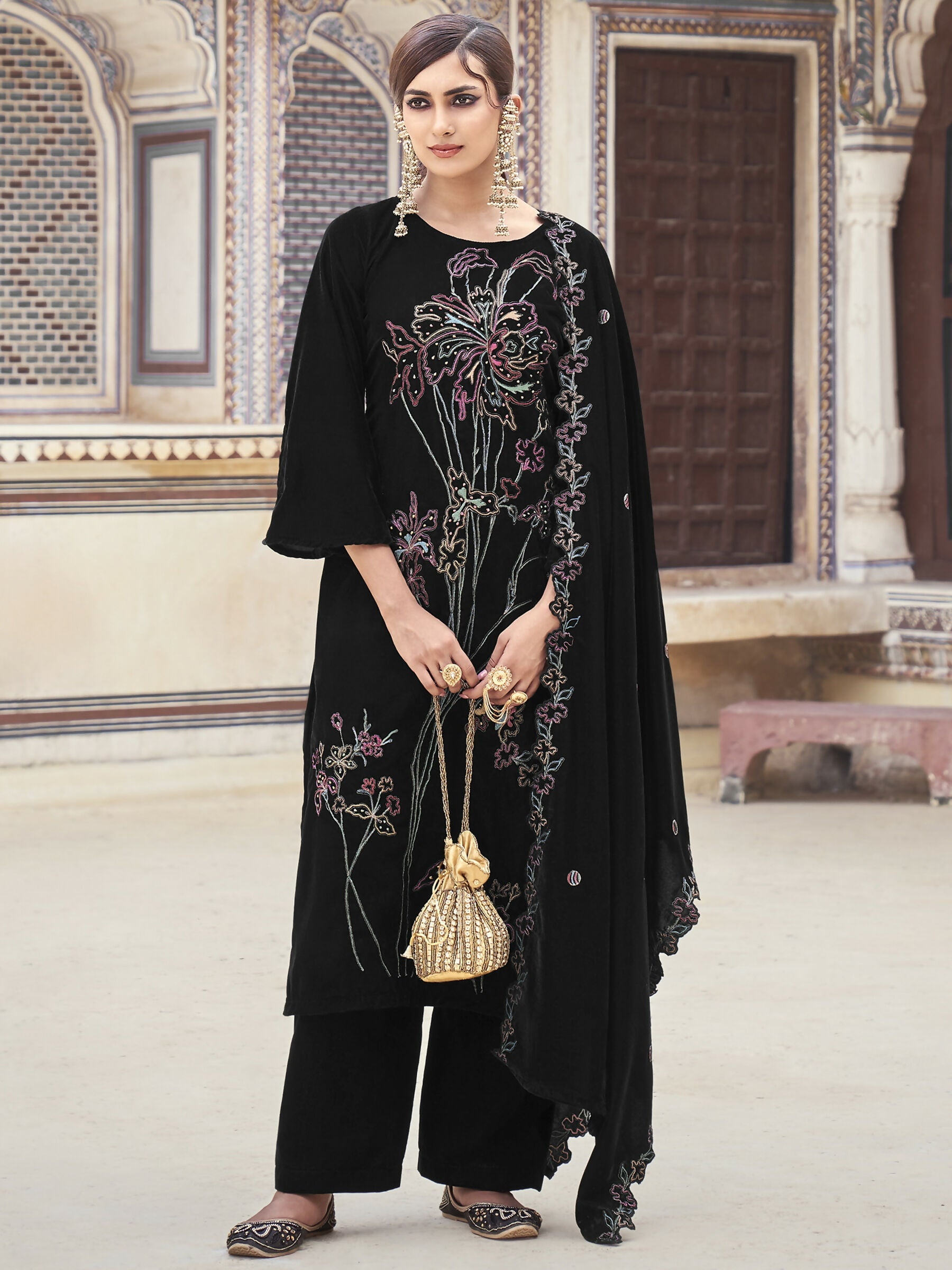 Black velvet straight kurta set with intricate Resham thread, Jari, and sequin embroidery and matching trousers.