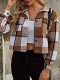 Woman wearing a brown plaid collared cropped jacket, showing the patterned fabric and structured collar.