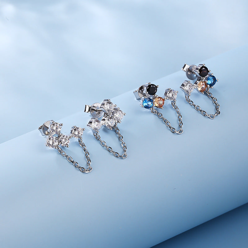 Elegant asymmetric silver drop earrings with colorful zircon and tassel detail