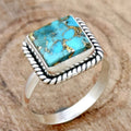 Elegant southwestern style silver ring with bohemian design details on a neutral background