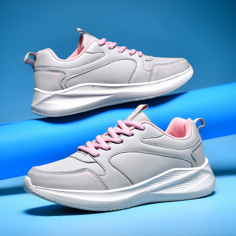 Women’s casual waterproof leather sneakers shown in grey and black colorways on a blue background.