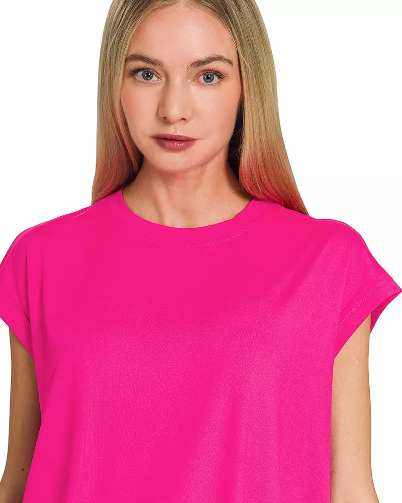 Woman wearing a bright pink t-shirt on a white background
