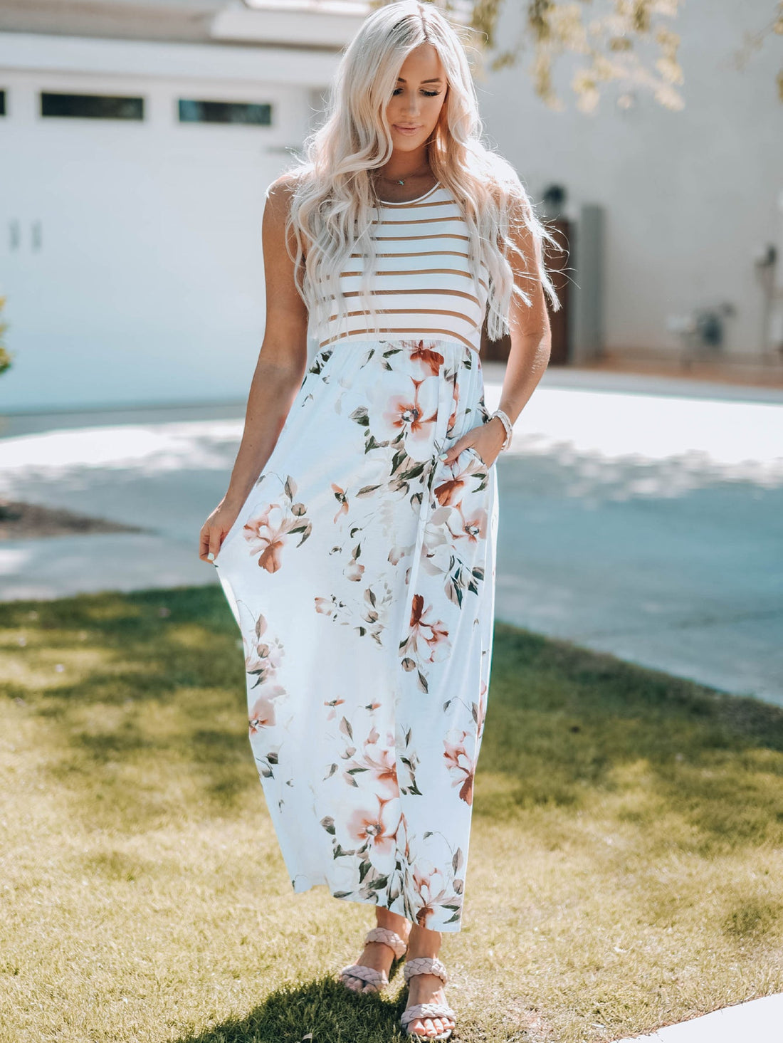 Zora sleeveless maxi dress with mixed stripe and floral pattern, featuring side pockets