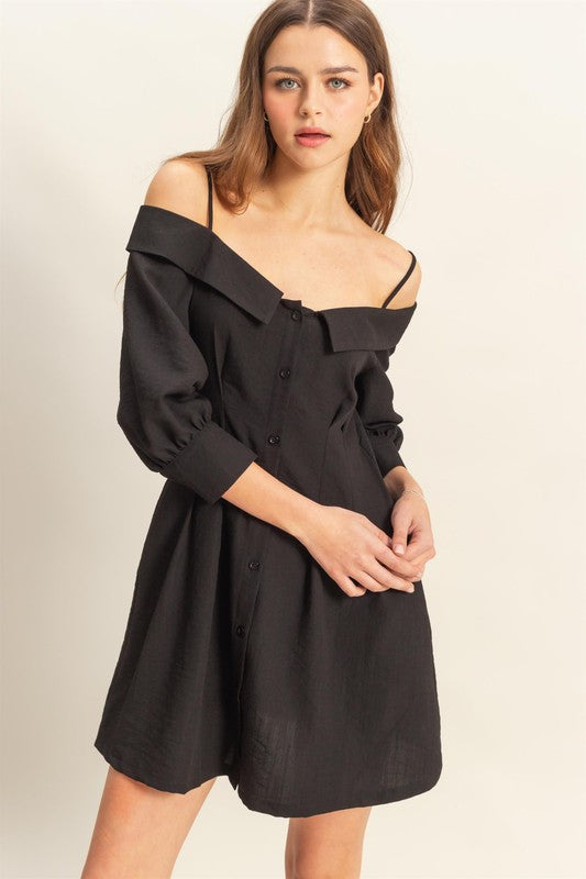 A black button-down mini dress with spaghetti straps and functional pockets.