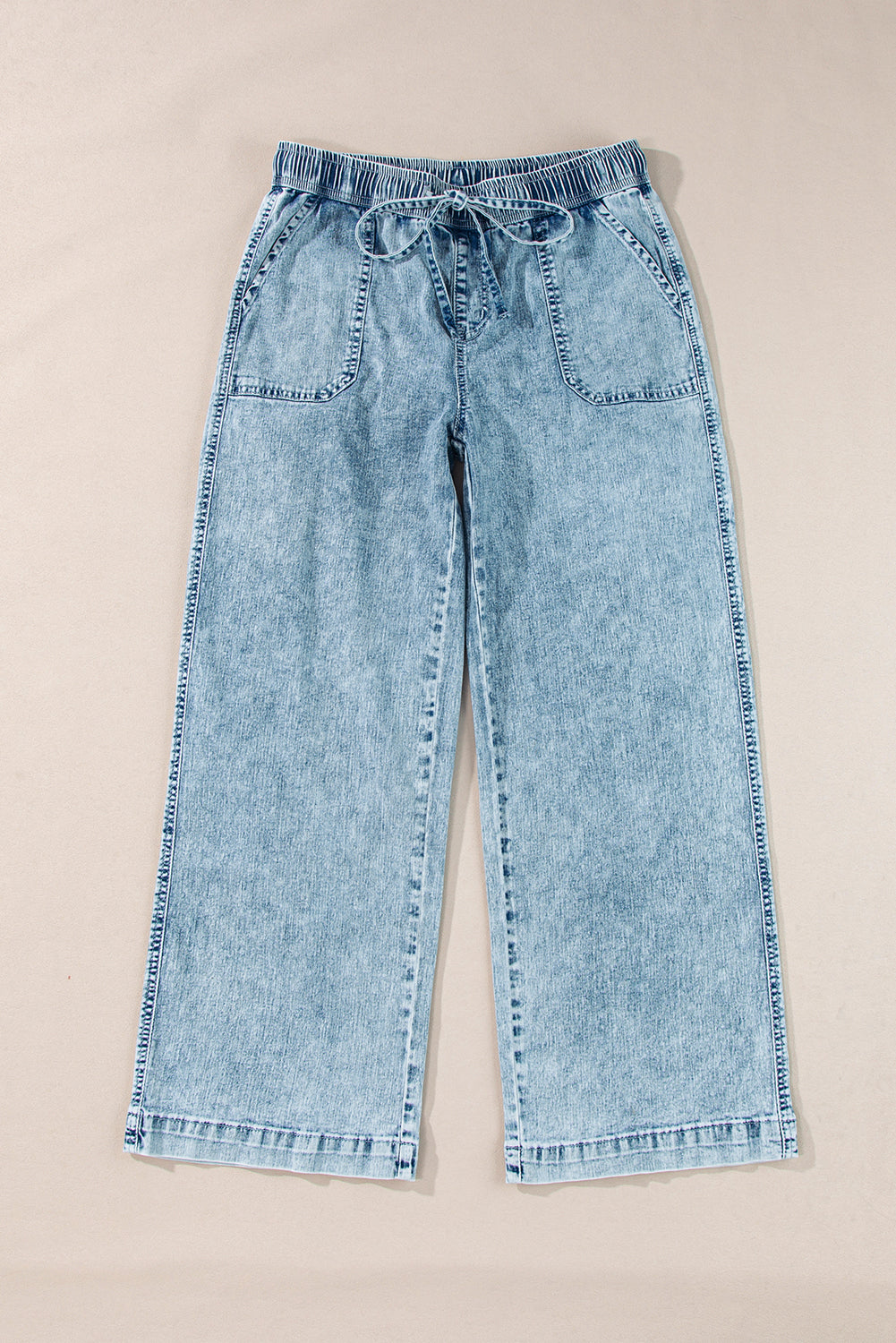 Yamileth light blue mineral wash loose straight leg pants with elastic drawstring waist and front pockets on a neutral background
