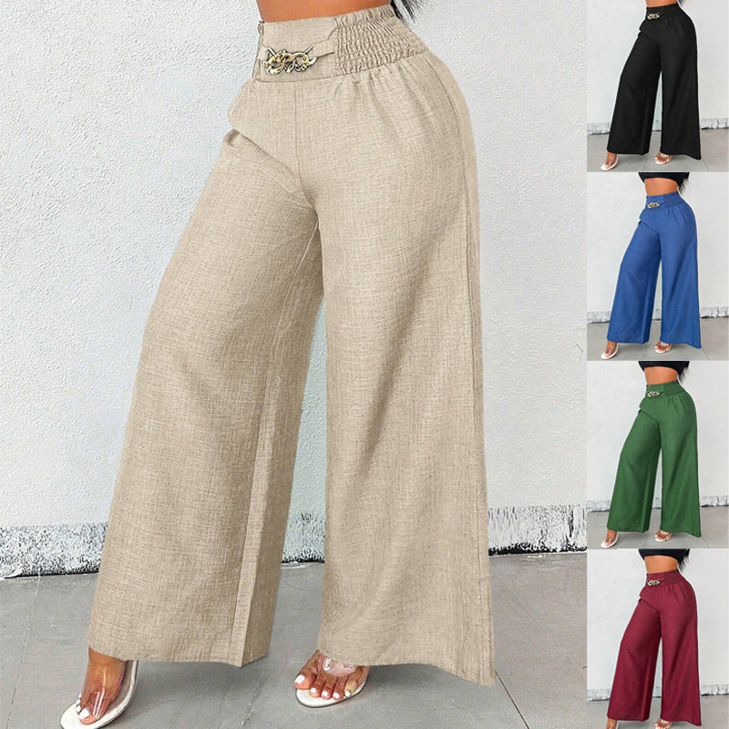 A woman wearing beige high-waist wide-leg pants with an elastic drawstring waist and chain detail.