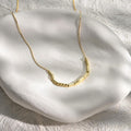 Elegant gold minimalist Morse code custom name necklace worn on a model.