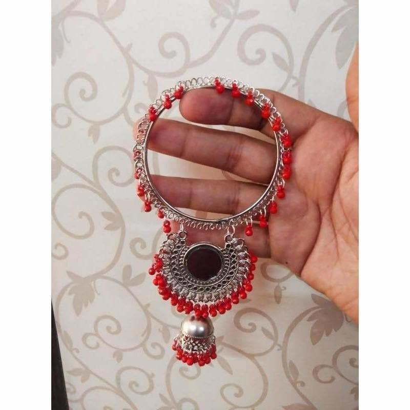 Silver-tone bangle with vibrant red pearl accents and hanging jhumki charms