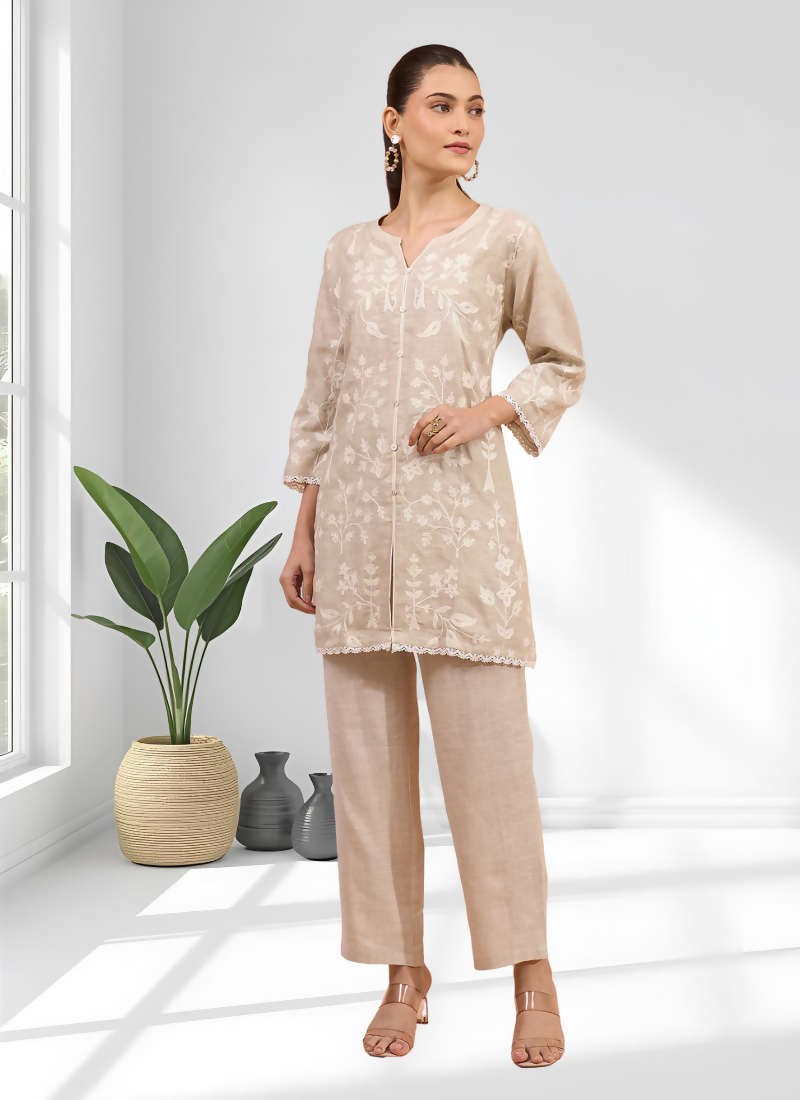 Close-up view of a beige linen cord set featuring detailed embroidery on the bodice