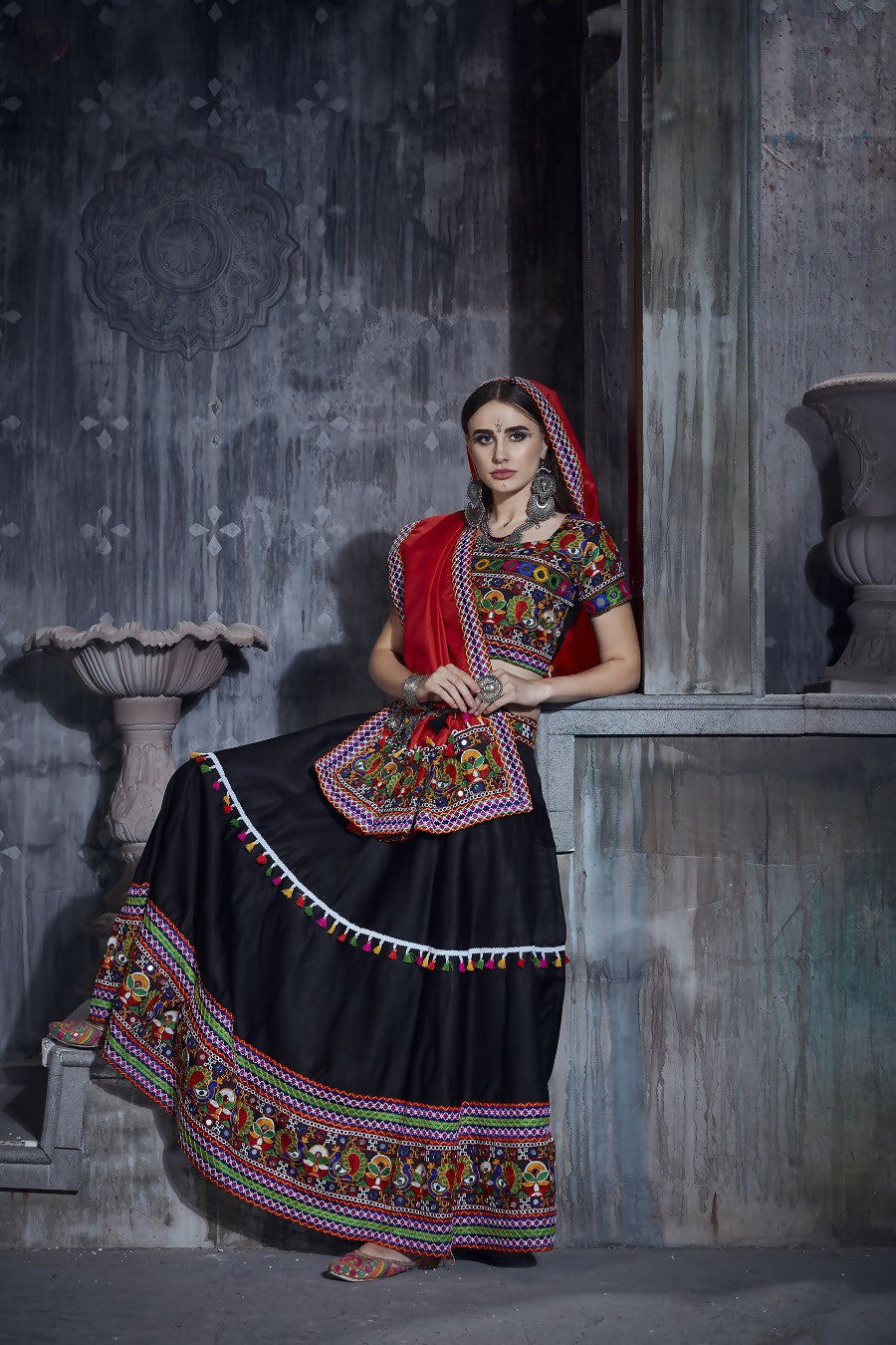 Black art silk Navratri lehenga choli with a multi-colored blouse and red dupatta
