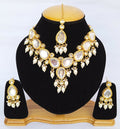 White Kundan stone necklace set with gold plating and elegant traditional design.