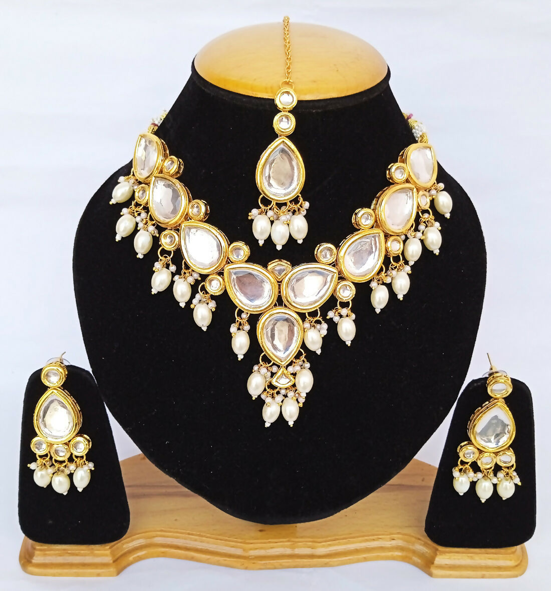 White Kundan stone necklace set with gold plating and elegant traditional design.