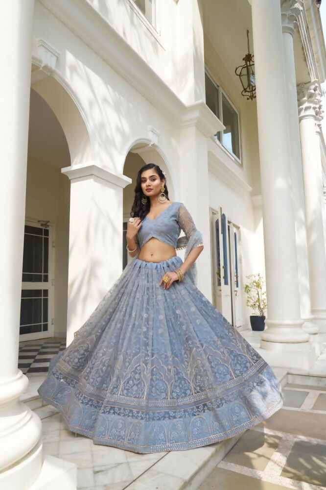 Light blue gray butterfly net wedding lehenga choli with intricate thread and sequence embroidery.