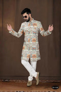 Close up of Pista base Georgette Kurta with intricate thread and sequence embroidery paired with white pyjamas