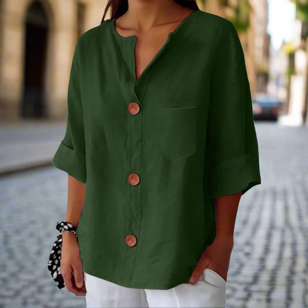 A woman wearing a loose-fit v-neck button-up top made of cotton-linen blend fabric.