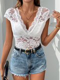 Woman wearing a white lace v-neck backless bodysuit with cap sleeves and tie-back detail