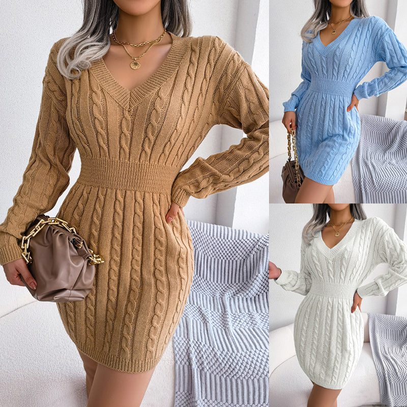 A woman wearing a tan V-neck cable knit long sleeve bodycon sweater dress