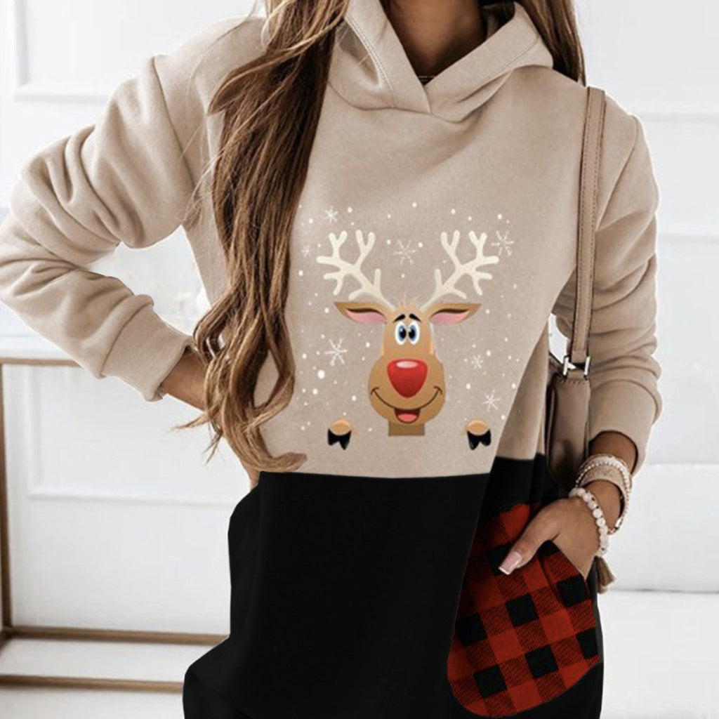 Woman wearing a beige and black hooded sweatshirt dress with a deer print and plaid pocket detail
