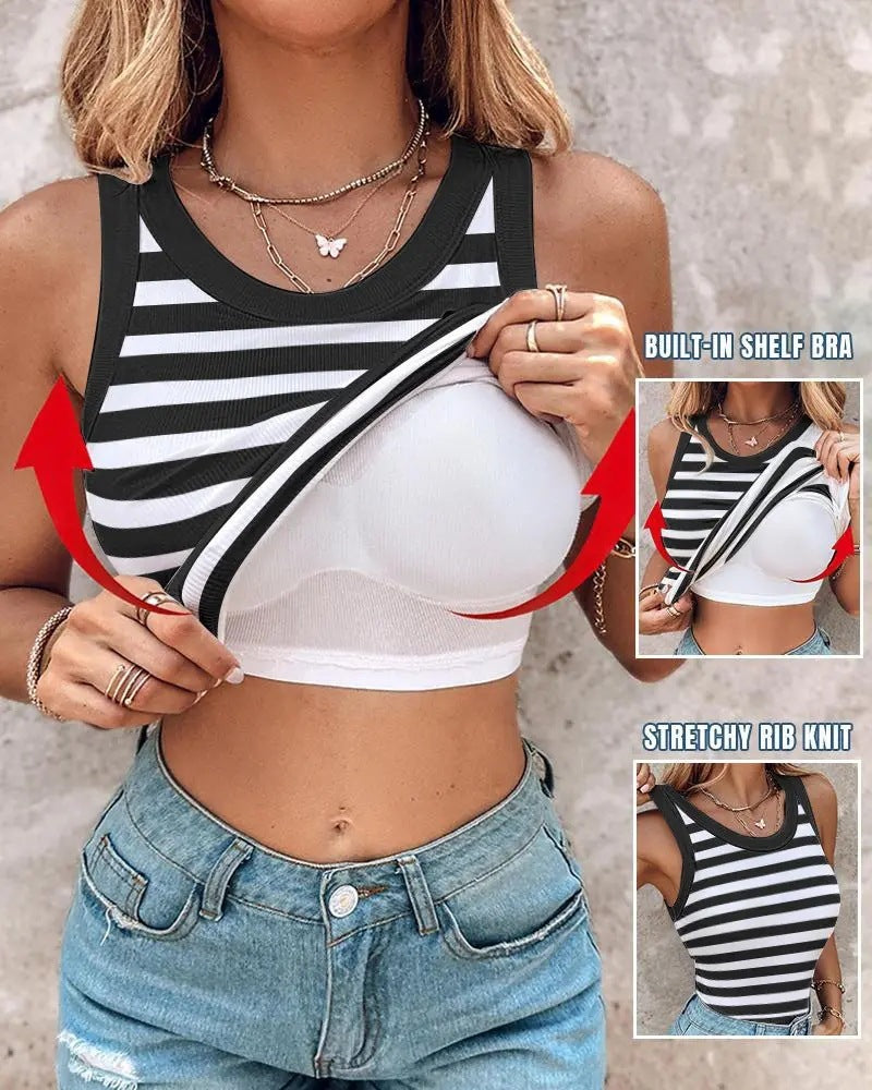 A woman wearing a slim-fit black and white striped ribbed tank top with an integrated white shelf bralette shown pulled up to display the construction.