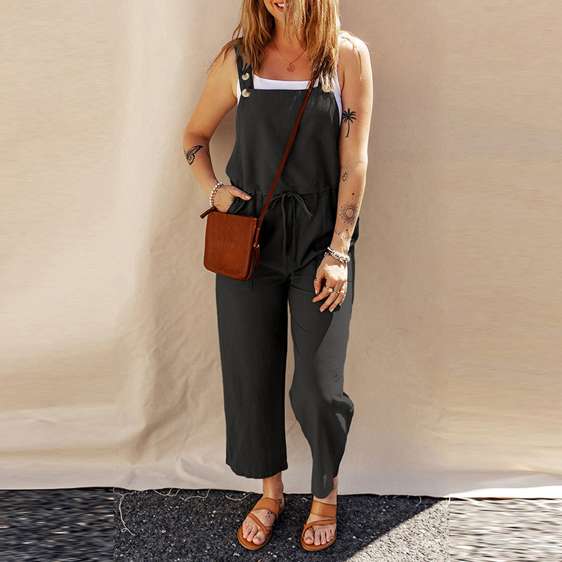 Women wearing a sleeveless black linen camisole jumpsuit with a wide-leg silhouette and square neckline.