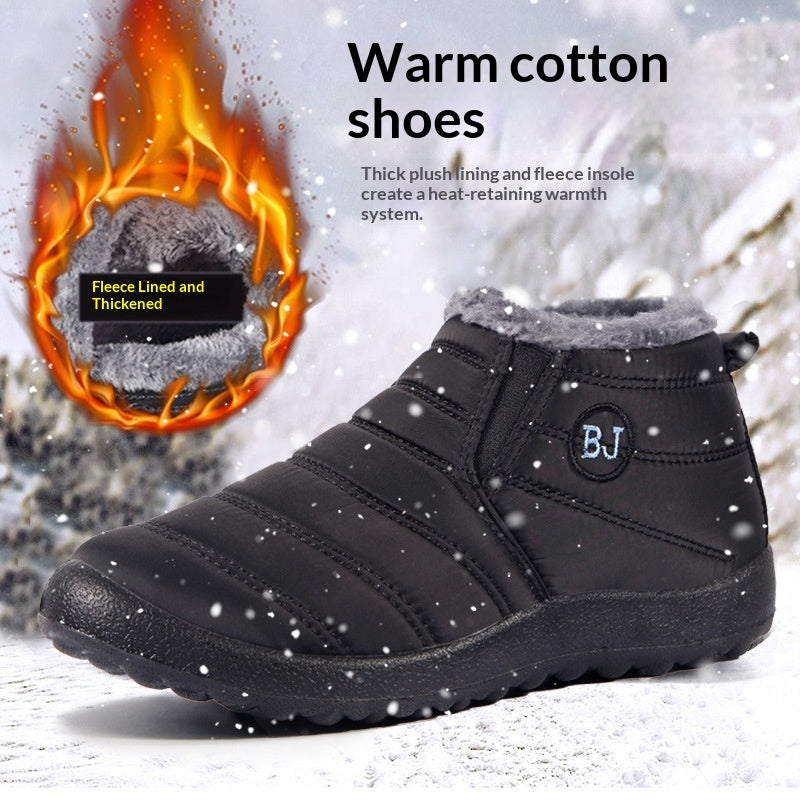 A black, fleece-lined, lightweight winter ankle boot sitting on a snowy surface.