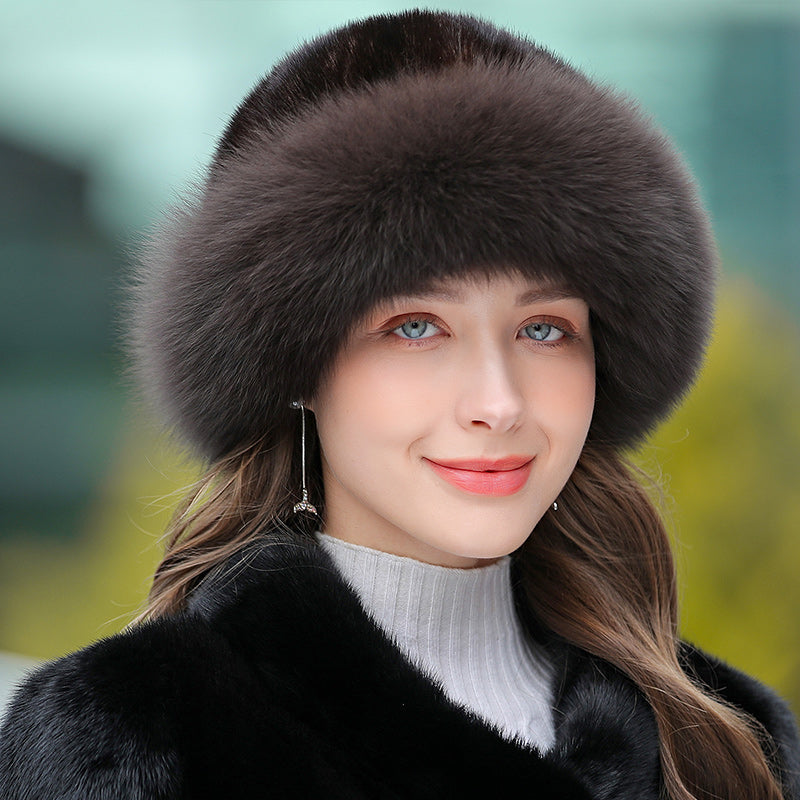 A woman wearing a soft, dark brown luxury-style faux fur winter bucket hat