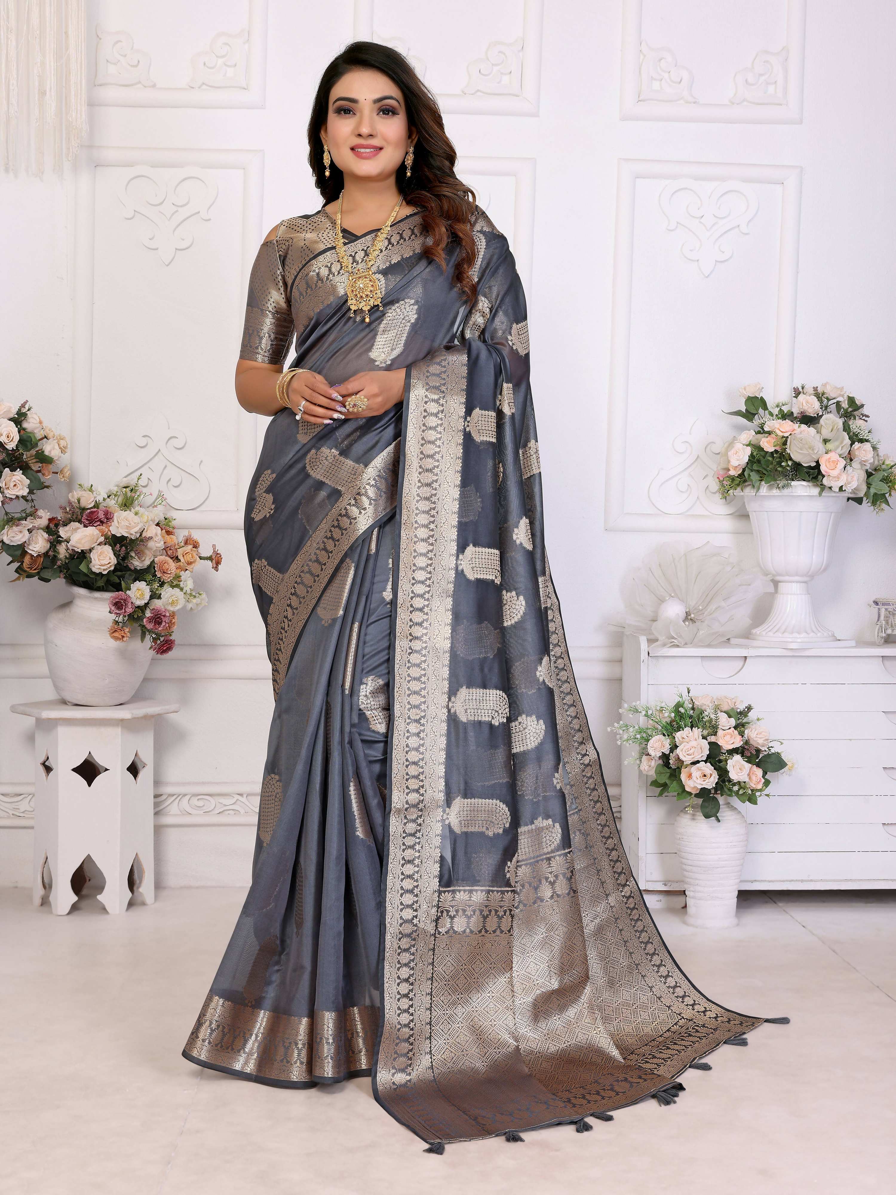 Grey soft organza silk saree with intricate weaving work draped elegantly