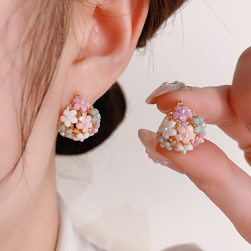 Elegant gold-tone flower earrings featuring zircon and pearl accents for a professional look.