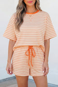 Woman wearing a peach and orange striped loose tee and matching knit shorts set.