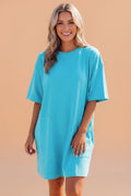 Model wearing a bright blue oversized cotton crew neck drop shoulder mini t-shirt dress with side pockets