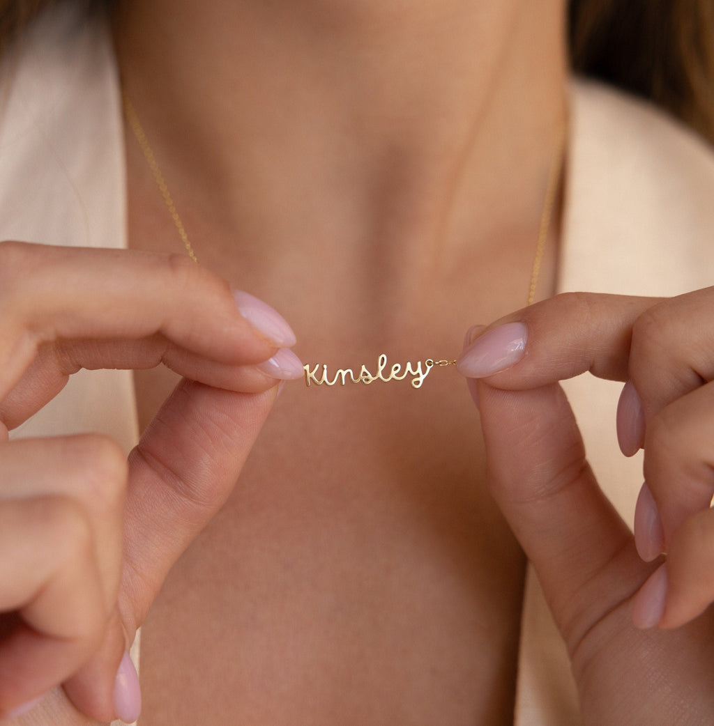 Custom minimal gold script name necklace styled for an elegant everyday look