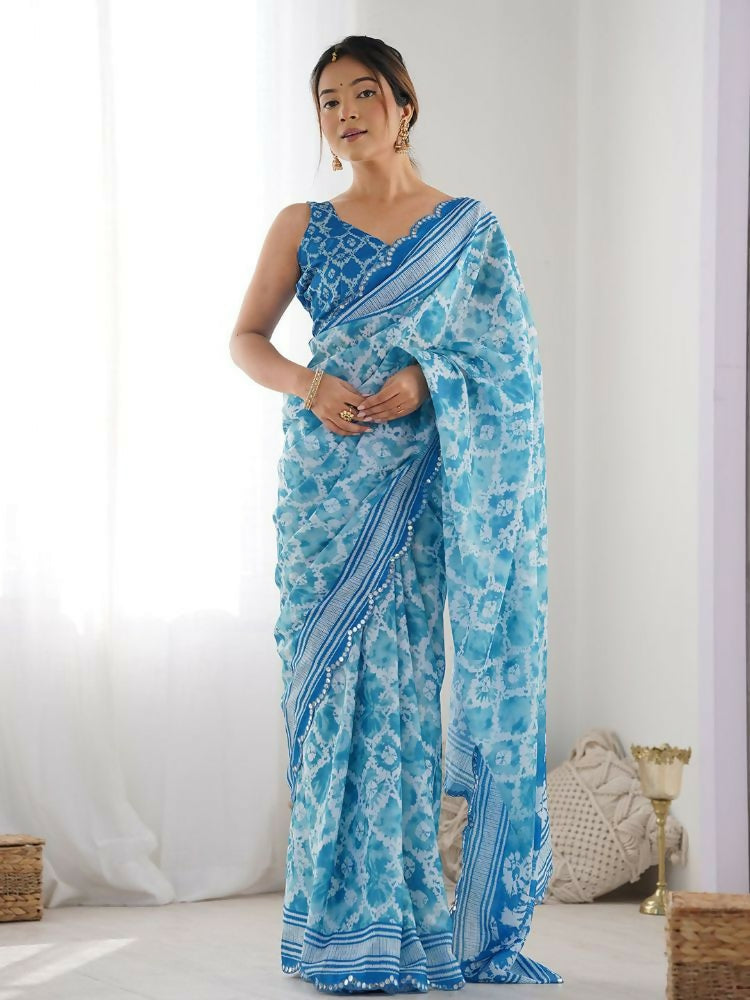 Sky blue georgette saree featuring digital print and festive mirror work embellishments