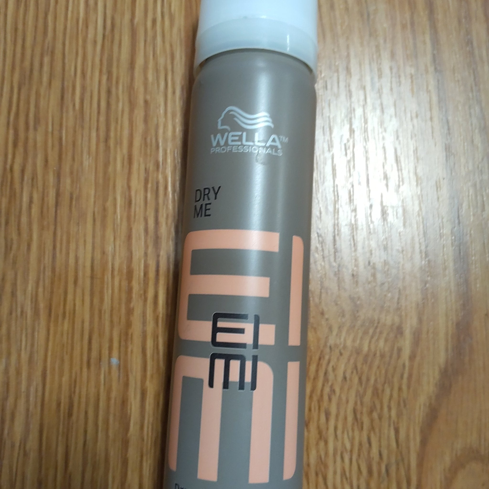 Wella Eimi Dry Me Dry Shampoo 1.35 oz travel-sized bottle for oil control and volume.