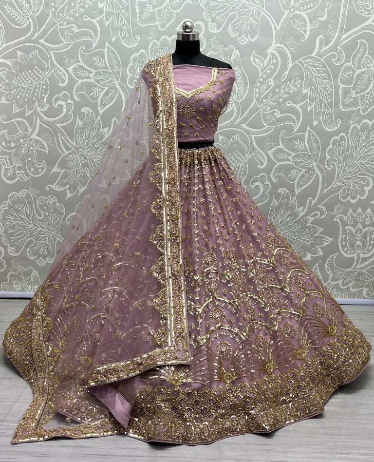 Women wearing a Pyazi bridal net lehenga choli with gold sequins and multi-thread handwork