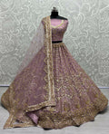 Women wearing a Pyazi bridal net lehenga choli with gold sequins and multi-thread handwork