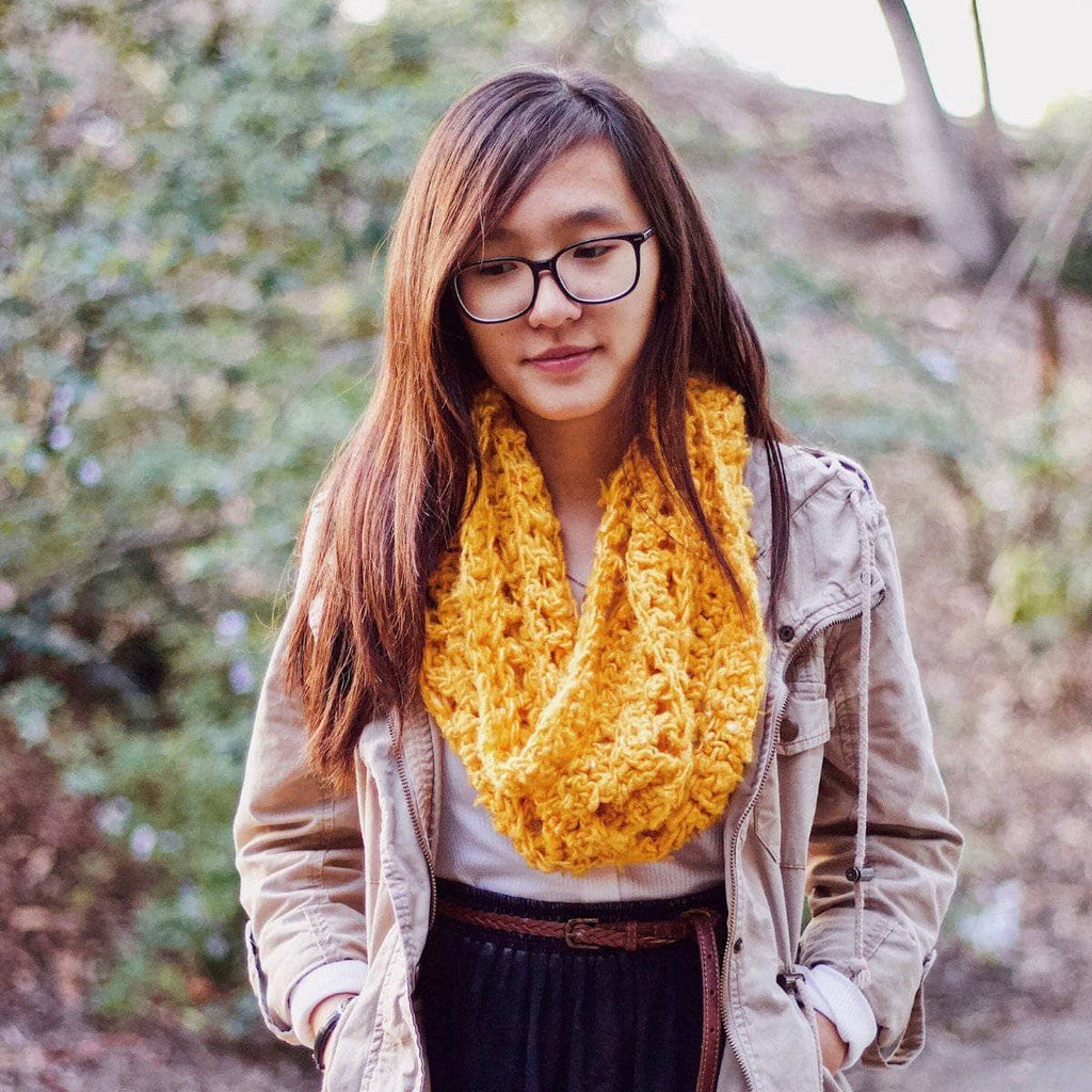 Vibrant mustard yellow ribbed banana fiber cowl worn in a casual bohemian setting