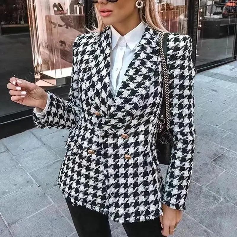 Close up of a girls black houndstooth tweed jacket with tassel fringe and vintage-style buttons.
